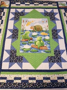 a quilted table topper with a pond scene on it