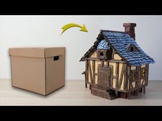 a cardboard box sitting next to a model house