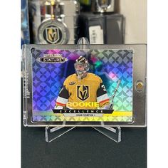 a hockey card with a player on the front and back of it in a display case