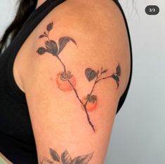 a close up of a woman's arm with tattoos on it and flowers in the middle