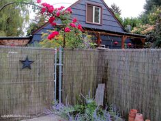 a fence that has some flowers in it