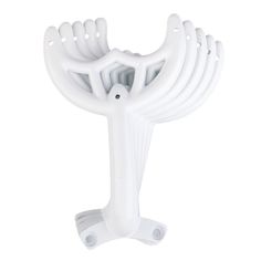 a white plastic object with four arms and two feet on it's base, against a white background