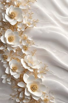 an image of white flowers with gold leaves on the side of a bed sheet that is drapeed in satin material