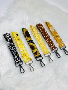 five lanyards are lined up on a furry surface