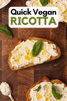 two pieces of bread topped with ricotta cheese and basil on a wooden cutting board