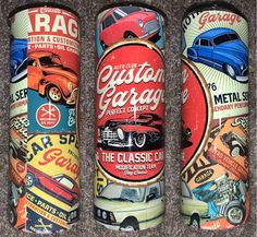 three cans with different types of cars on them sitting on a carpeted floor next to each other