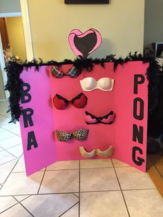 a pink sign that says pong with some glasses on it