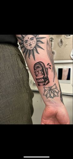 a person with a tattoo on their arm holding up a clock and sun in the background