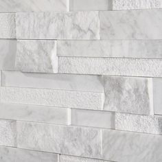 a white marble brick wall is shown