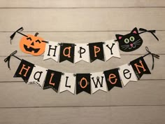 a happy halloween banner with black cats and pumpkins hanging from it's sides