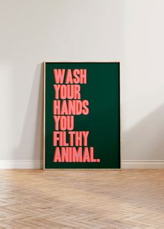 a green poster with the words wash your hands you filthy animal in pink on it