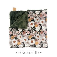 a blanket with flowers on it and the words olive cuddle in front of it