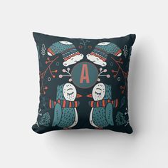 a decorative pillow with two owls on it, and the letter a in the middle