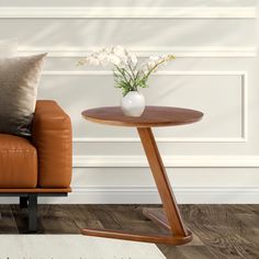 a living room with a brown leather chair and white flowers in a vase on the end table