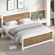 a white bed with wooden headboard and foot board next to nightstands in a bedroom