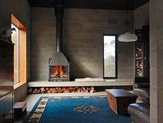 a living room filled with furniture and a fire place next to a window on top of a rug