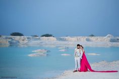 a man and woman posing for a photo in front of the blue lagoons at pamos