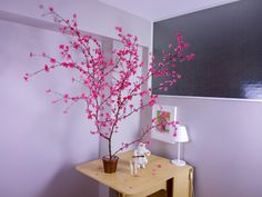 pink flowers in a vase on a small table