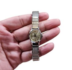 This vintage Timex wristwatch is a unique addition to any watch collection. The stylish silver band and white dial give it a classic look that is perfect for casual wear. The watch is a wind-up style with a mechanical manual movement, making it a true vintage piece.  The case is made of durable stainless steel and the display is analog. While the watch needs a battery, it is missing and not included in the sale. This wristwatch is classified under the categories of jewelry and watches, parts and accessories, and wristwatches. It is specifically designed for women and features the Timex brand. Cheap Retro Analog Watch Accessories, Women Wrist Watch, White Dial, Watch Collection, Wrist Watches, True Vintage, Silver Band, Up Styles, Classic Looks