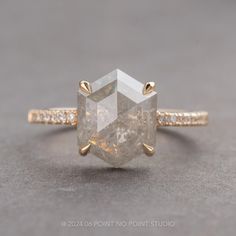 an engagement ring with a large white diamond in the center and two yellow gold bands around it