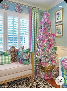 a brightly colored christmas tree is in the corner of a living room with leopard print pillows