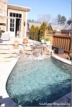 a small pool with a waterfall in the middle