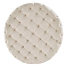 an upholstered white round plate with buttons on the center and sides, isolated against a white background