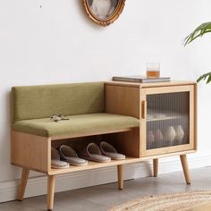 a wooden bench sitting next to a wall with a mirror on it's side