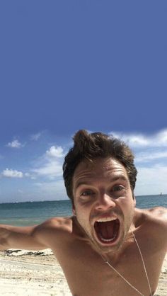 a man on the beach with his mouth open