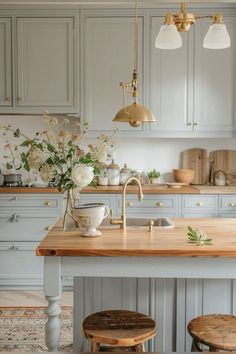 a kitchen with an island and stools next to the counter top in front of it