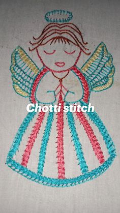 an embroidered angel is shown on the side of a piece of cloth, which has been stitched together