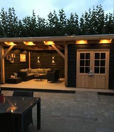 an outdoor living area is lit up at night