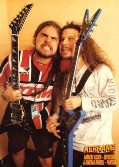 two men with long hair and beards are posing for a photo while holding guitars