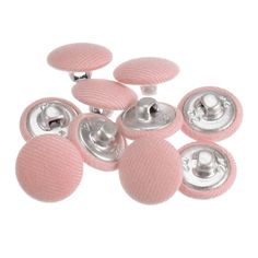 six pink buttons with silver centers on a white background