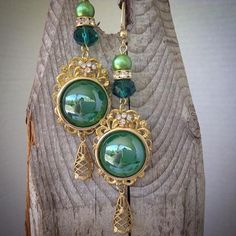 These pretty earrings are made using emerald green cabochons , brass filigree and glass pearls Elegant Green Cabochon Earrings, Green Filigree Drop Earrings, Green Cabochon Jewelry For Party, Green Filigree Earrings For Formal Occasions, Green Filigree Teardrop Earrings, Green Teardrop Filigree Earrings, Green Formal Filigree Earrings, Formal Green Filigree Earrings, Vintage Green Brass Earrings