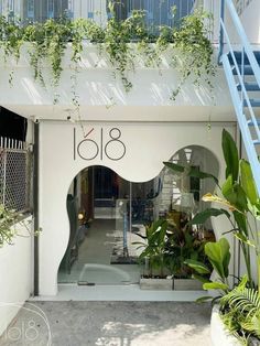 the entrance to an apartment building with plants and stairs