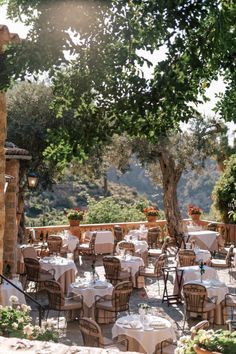 an outdoor dining area with tables and chairs