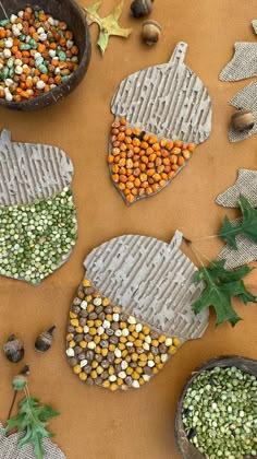 some food is laying out on a table with leaves and acorns around it