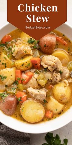 a white bowl filled with chicken stew and potatoes