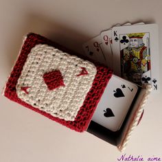 a crocheted card holder with playing cards in it