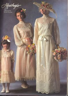 two women and a girl in dresses with flowers on their heads are standing next to each other