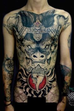 a man with tattoos on his back and chest