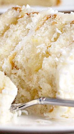 a close up of a piece of cake on a plate with a fork in it