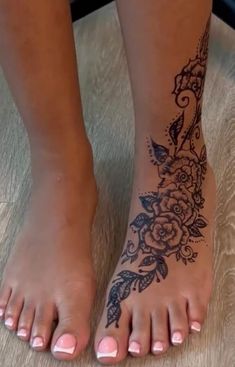 a woman's foot with a flower tattoo on it