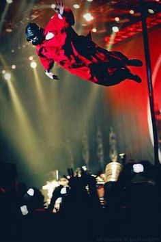 a man flying through the air while riding a skateboard on top of a stage