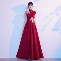 Long Embroidered Cheongsam For Wedding, Embroidered Long Cheongsam For Wedding, Wedding Cheongsam With Embroidered Stand Collar, Wedding Cheongsam With Stand Collar And Embroidery, Embroidered Floor-length Ao Dai For Wedding, Long Cheongsam For Wedding, Floor-length Ao Dai For Ceremonies, Full-length Floral Embroidered Wedding Gown, Full-length Wedding Gown With Floral Embroidery