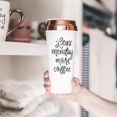 a person holding up a coffee cup with the words less monday more coffee on it