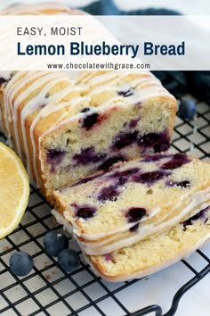 lemon blueberry bread with icing on a cooling rack next to a sliced lemon