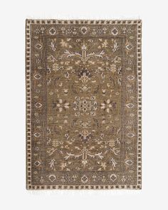 a brown and beige rug with an intricate design