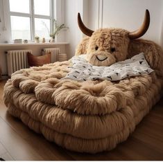 a large stuffed animal sitting on top of a bed in the middle of a room